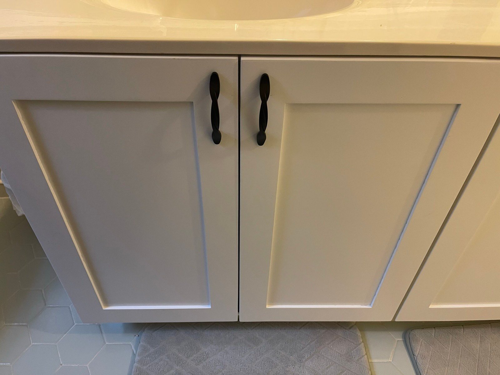 Painted custom storage cabinetry fitted tightly along a room wall.